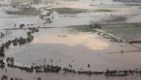 Australia flood warnings spread, Brisbane mops up