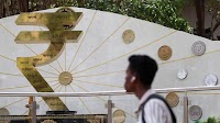 Rupee trades in narrow range against U.S. dollar in early trade
