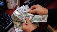 Dollar tiptoes down against dong