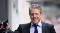 Hugh Grant settles claim against Sun publisher due to risk of £10m legal costs
