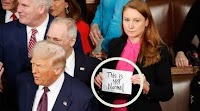 Democratic Rep Reveals ‘SOS’ Message Behind Her Viral ’NOT Normal’ Sign At Trump Speech