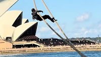 Moment man appears to try and scale cruise ship in Sydney