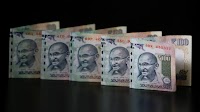 Rupee closes flat ahead of US-China trade talks; ends at 85.63/$