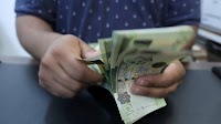 Libya devalues currency for first time in four years