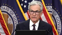 Fed holds interest rates steady, signals rate cuts of 0.5% later this year