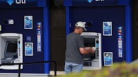 Americans are taking out cash like mad and bleeding ATMs dry. Here's why that's a bad idea.