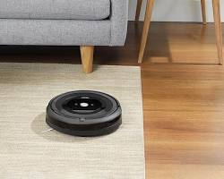 Изображение: robot vacuum cleaning under furniture