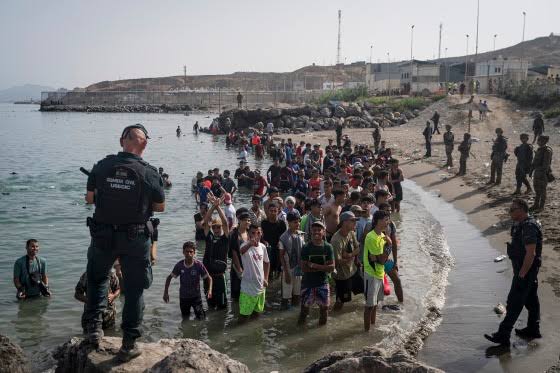 Spain's migration surge in Ceuta tests EU border policy as 72,000 enter, 77 die, and authorities reinforce maritime barrier