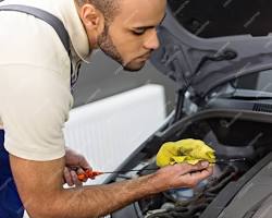 mechanic checking engine oil resmi