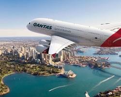 Image of Emirates plane flying over Sydney Opera House