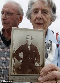 Patricia Watt with her husband David, holds a picture of her grandfather George Mackie, who died on Titanic - article-2130009-129274D7000005DC-25_306x423