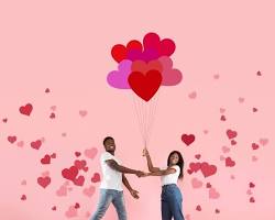 Image of happy couple holding hands with a heartshaped balloon