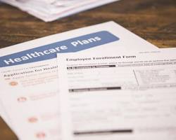 Image of confused healthcare provider looking at a bunch of numbers