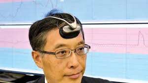 Hitachi engineer Takeshi Ogino dispays a portable &#39;brain-machine&#39; interface equipped with an optical sensor in a headset to measure prefrontal bloodstream, ... - world_15_temp-1316154532-4e72eca4-620x348