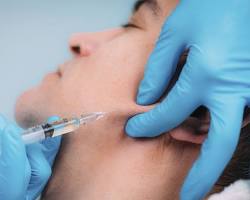 Image of syringe injecting filler into a person's face