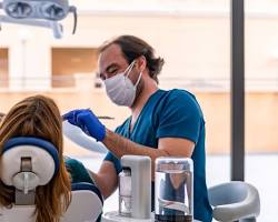 Image of Dental assistant assisting the dentist