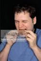 Man Eating Chicken Wing - Stock Photos - 700-00286264em-Man-Eating-Chicken-Wing---