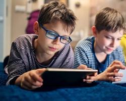 Изображение: child listening to an AIpowered interactive storybook that animates the characters and scenes as they read along