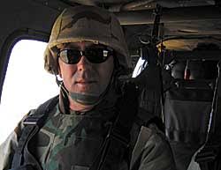 Navy Cmdr. and GW Law School student Rex Guinn, aboard a helicopter en route to Hatra, where hundreds of Kurds executed by Saddam Hussein&#39;s regime were ... - guinn