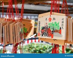 children writing their wishes on ema (wooden prayer plaques) at Dazaifu Tenmangu Shrine.の画像