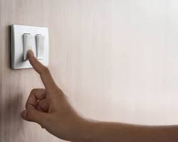 person turning off lights when leaving a room