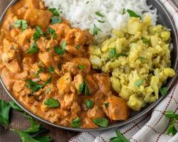 Image of Aloo Masala served on a plate with rice and naan