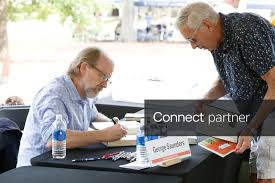 Licensable picture: Author George Saunders signs a copy of one of his books during the Mississippi Book Festival in Jackson, Miss., on Sept. 26
