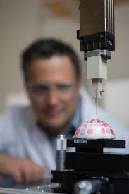 A blurry Facundo Fernandez, project lead, with the robotic arm held probe for mapping uneven surfaces. (via Georgia Tech). How did life begin here on Earth? - fernandez-robotic-arm-closeup1