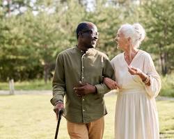 elderly couple enjoying a walk in the parkの画像