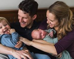 family looking at their newborn photoshoot album