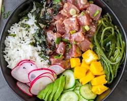 various Hawaiian poke bowls with fresh ingredients displayed on a counterの画像