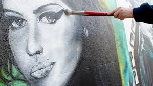 Street graffiti artist Jason Howarth otherwise known as &#39;Camden Care&#39; applies finishing touches to an Amy Winehouse mural in Camden in aid of the Amy ... - image