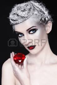 Portrait of young woman with fancy make-up and red gem in hand Stock Photo Portrait of young woman with fancy make-up and red gem in hand - 15278881-portrait-of-young-woman-with-fancy-make-up-and-red-gem-in-hand