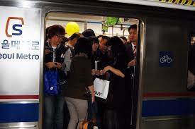 Image result for people being shoved in a train