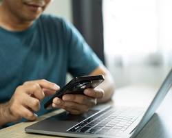 صورة person using mobile phone to shop online