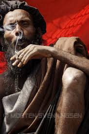 Rasta-style Hindu holy man is smoking a joint at the Mahashivratri festival in Nepal 2007. By Nepal Photographer Morten Svenningsen - rasta-smoking