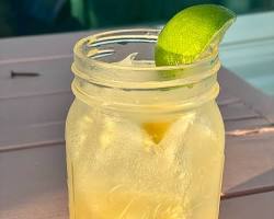Image of person filling up a mason jar with a margarita