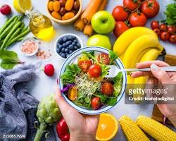 صورة person eating a colorful salad with a variety of fruits and vegetables