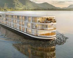 A luxurious cruise ship on the Mekong River at sunset.