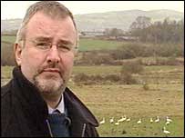 BBC Northern Ireland rural affairs correspondent Martin Cassidy. Swans are wary of humans and Martin Cassidy could not get closer - _39529754_martinswan203