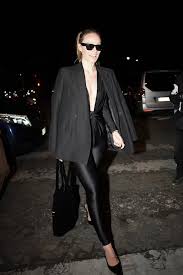 Olivia Wilde's Shimmering Catsuit Dips to Her Stomach During a Night Out at Paris Fashion Week