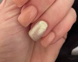 Image of hand with nude nails with a single silver glitter accent nail