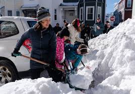 More snow falls on the Northeast, where huge piles remain from the last storm