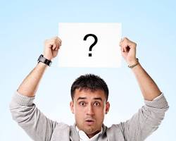 Image of person holding up a question mark