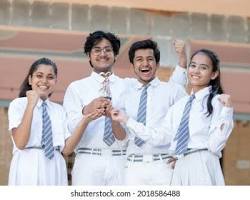 high resolution photo of Indian secondary school students in uniform studying in classroom and celebrating success, AI generated