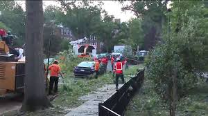 Crews clean up fallen gas station canopy and trees after storms lash Northwest DC