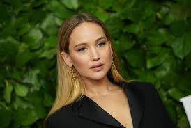 Jennifer Lawrence Goes Makeup-Free in a Butter Yellow Wrap Coat Paired With an Unexpected Bag