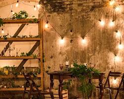 Gambar cozy coffee shop interior with soft lighting, wooden furniture, and plants