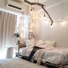 Image result for Few accents also help create a mellow mood. Here, a low-lying bed aligned with a light wooden bedside table and simple potted plant.