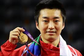 Zi Yang of Singapore poses with the gold medal after winning the Men&#39;s Singles Gold Medal Match between Ning Gao of Singapore ... - Zi%2BYang%2B19th%2BCommonwealth%2BGames%2BDay%2B11%2BTable%2BSmhTrVfRIlll